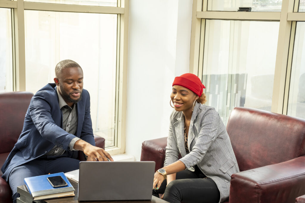 A mentor and mentee review ideas together, showcasing the benefits of mentorship in building confidence and real-world skills.