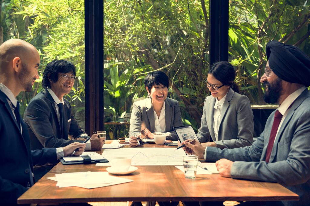 Professionals collaborating on business transition planning with strategic discussions and performance insights.